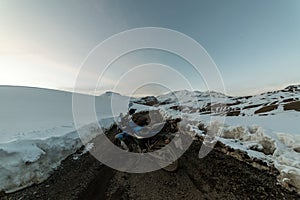 Spiti, Himachal Pradesh, India - March 26, 2019 : Biker at open road in winter in himalayas of india