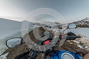 Spiti, Himachal Pradesh, India - March 26, 2019 : Biker at open road in winter in himalayas of india