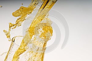 Splash of alcohol light beer out of a glass