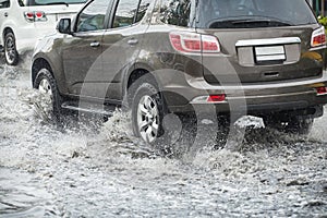 Splash by a car as it goes through flood water