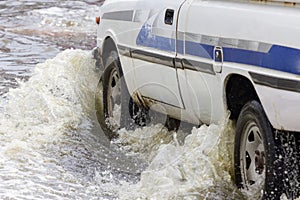 Splash by a car as it goes through flood water