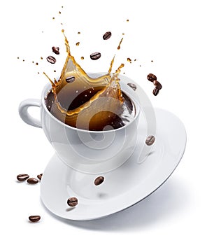 Splash of coffee in white cup and coffee beans in air. Isolated on white