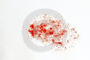 Splash of Dry organic kashmiri red chili pepper powder isolated on white  background selective focus,well known for dark r