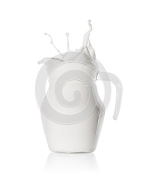 Splash of fresh milk in glass jug