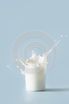 Splash of fresh organic milk in glass. Vertical format.