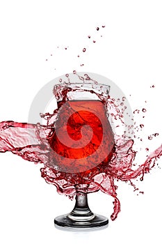 Splash in glass of red alcoholic cocktail drink