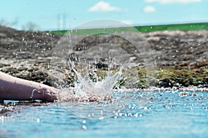 Splash hands in a puddle. a female hand clapping in a puddle