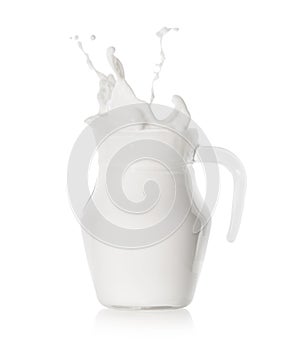 Splash of milk in a modern glass jug