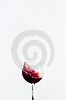 Splash red water in a wine glass with white background