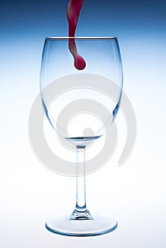 Splash red wine glass against a white background