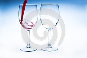 Splash red wine glass against a white background