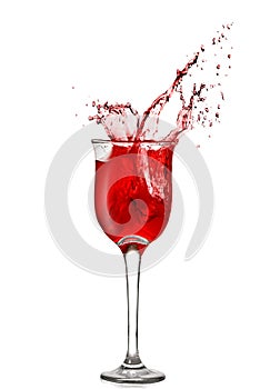 Splash of red wine in goblet photo