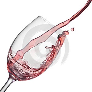 Splash of rose wine in wineglass on white