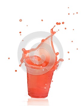 Splash of strawberry juice in a plastic cup