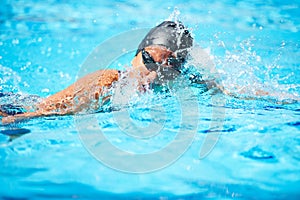 Splash, swimming and pool with a sports woman for training, cardio workout or exercise for fitness. Female athlete