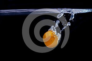 Splash of tangerine in water. freshness concept