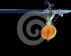 Splash of tangerine in water. freshness concept