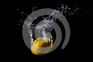 A splash of water around a fallen lemon