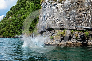 Splash in the water caused by somebody who jumped off a cliff