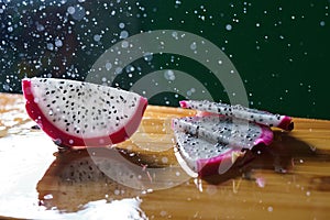 a splash of water drips into the pitaya