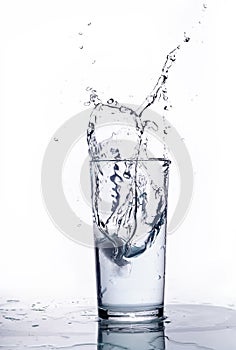 Splash of water in a glass beaker. White background
