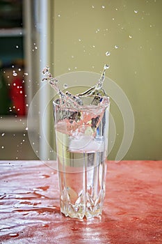 Splash of water in kitchen glass