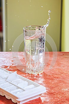 Splash of water in kitchen glass