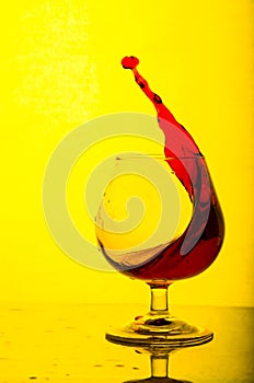 Splash of white wine in a glasson.