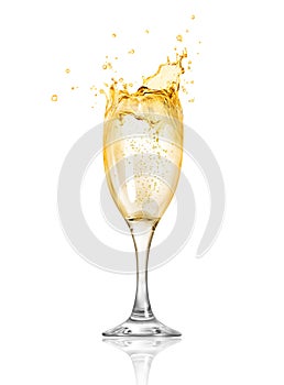 Splashes of champagne splash out of the glass.