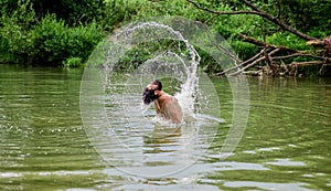 Splashes of freedom. Relaxation and rest. Swimming sport. Swimming skills. Man enjoy swimming in river or lake. Submerge