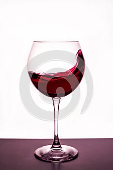 Splashes of red wine in a wineglass