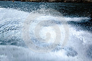 Splashes of water from a floating boat