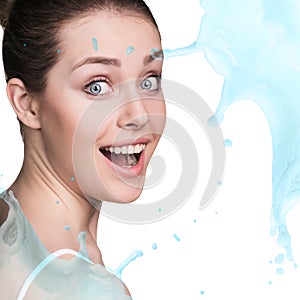 Splashes of water near beautiful woman`s face.