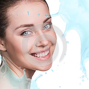 Splashes of water near beautiful woman`s face.