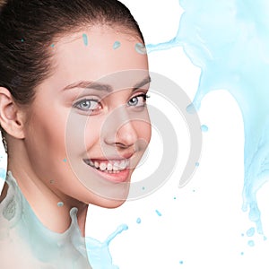 Splashes of water near beautiful woman`s face.