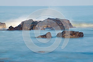 Splashes of waves on coastal rocks. Boulders beach splashes of waves.Landscape pictures