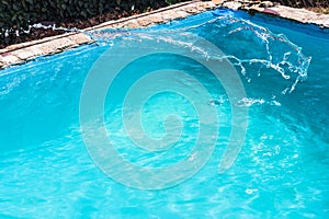 Splashing of disinfectant in outdoor swimming pool