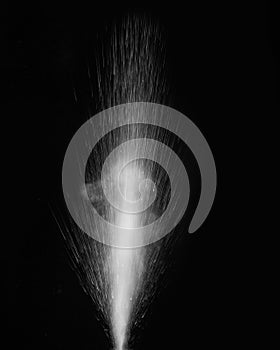 Splashing hot water with steam on a black background. Abstract background, design element