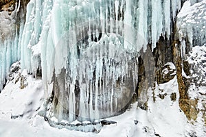 Splashing ice on coastal rock of lake Baikal