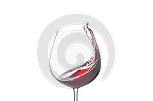 Splashing red wine in a glass on a white background close-up