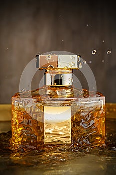 Splashing water around the golden perfume bottle