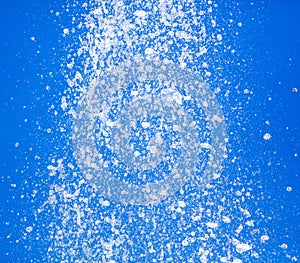 Splashing water from a fountain against the blue sky