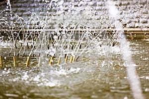 Splashing water in fountain. Water jets of pure clear aqua splashes, pressure