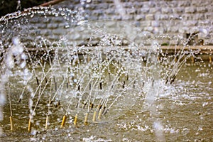 Splashing water in fountain. Water jets of pure clear aqua splashes, pressure