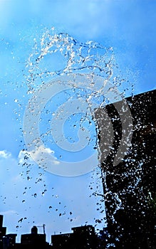 Splashing water isolated on blue background.