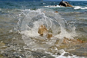 Splasing waves hit the rock