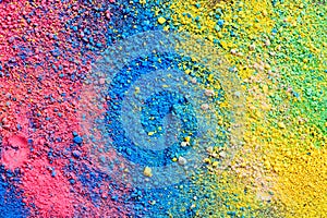 A splatter of pastel natural colored pigment powder on black background