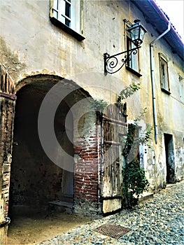 Splendid ancient door and wall in Saluzzo town, Piedmont region, Italy. History, enchanting architecture and art