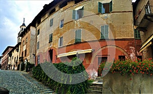 Splendid ancient street in Saluzzo town, Piedmont region, Italy. Colours, history, enchanting architecture and art