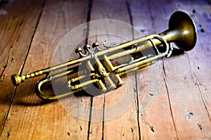 A splendid Jazz trumpet from the 1930s, on a wooden table from the 1920s